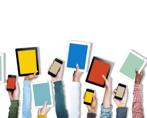 Various hands are raising mobile devices