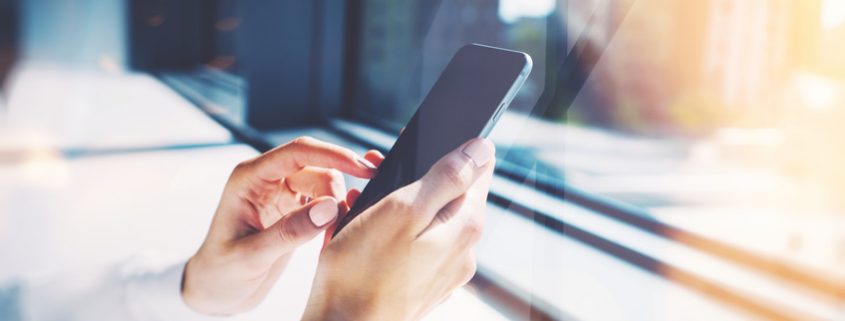 Girl touching a screen of her smarthone